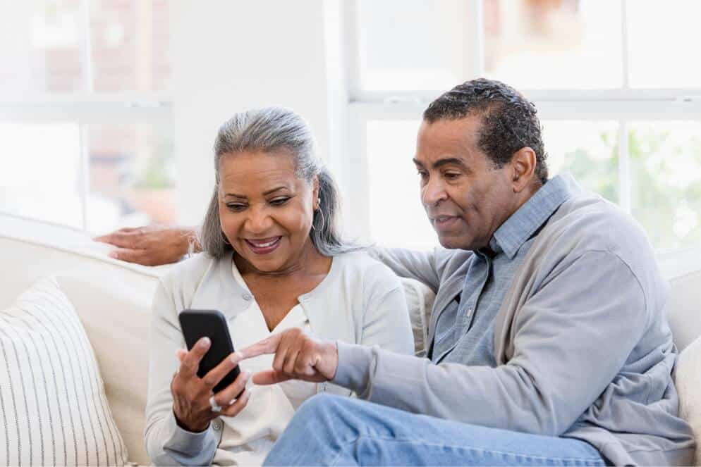 Couple viewing patient statements on a mobile device.