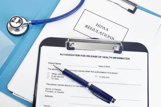 Image showing HIPAA regulations related to medical billing with a stethoscope, pen, and clipboard.