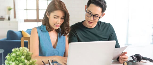 Young Asian Couple reading Clear Customer Communications