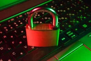 A computer keyboard with a padlock resting on it to symbolize protection of private health information in the medical billing process.