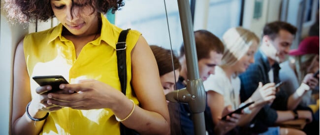 People on bus reading customer communications enabled by Nordis' ability to digitally transform customer correspondence