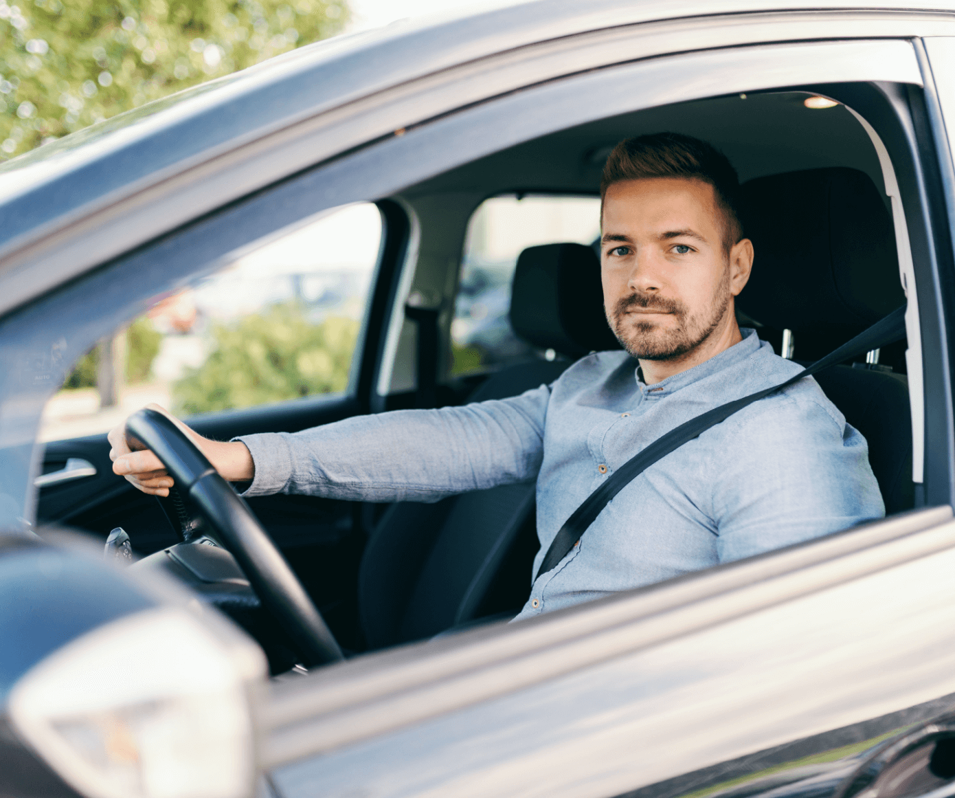 Young man driving new car